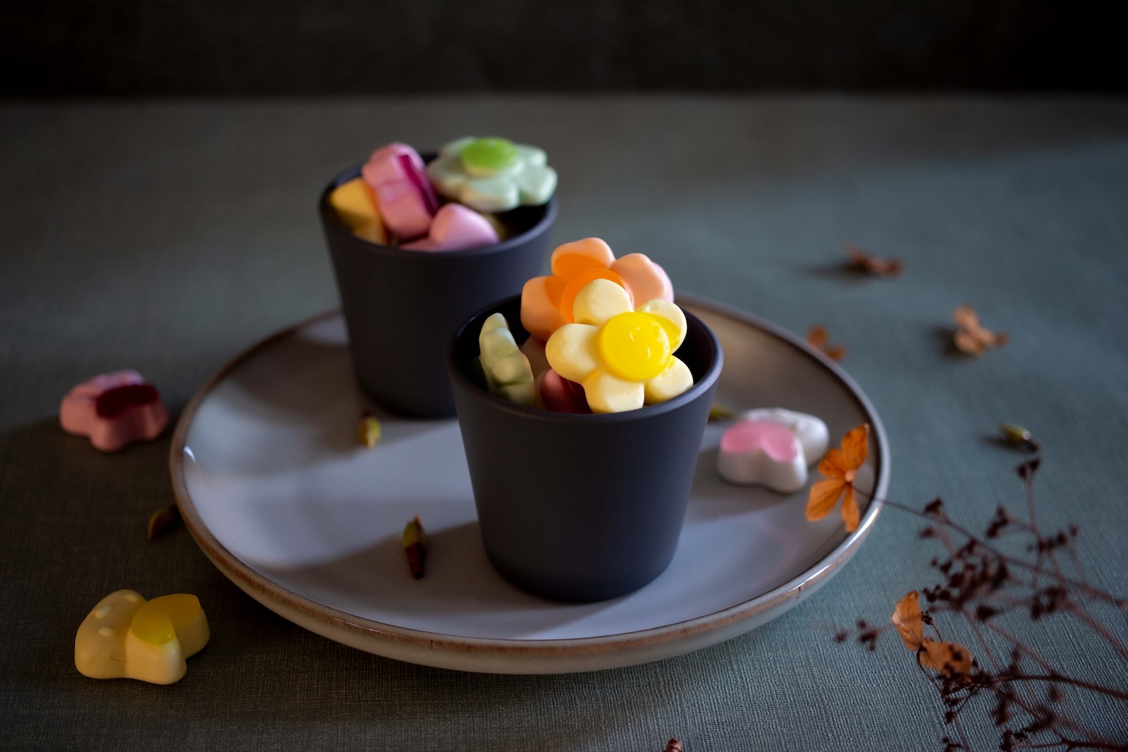a couple of cups filled with candy on top of a plate
